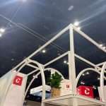 Overhead view of modular T3 Systems framework with custom curved structure at PGA Show